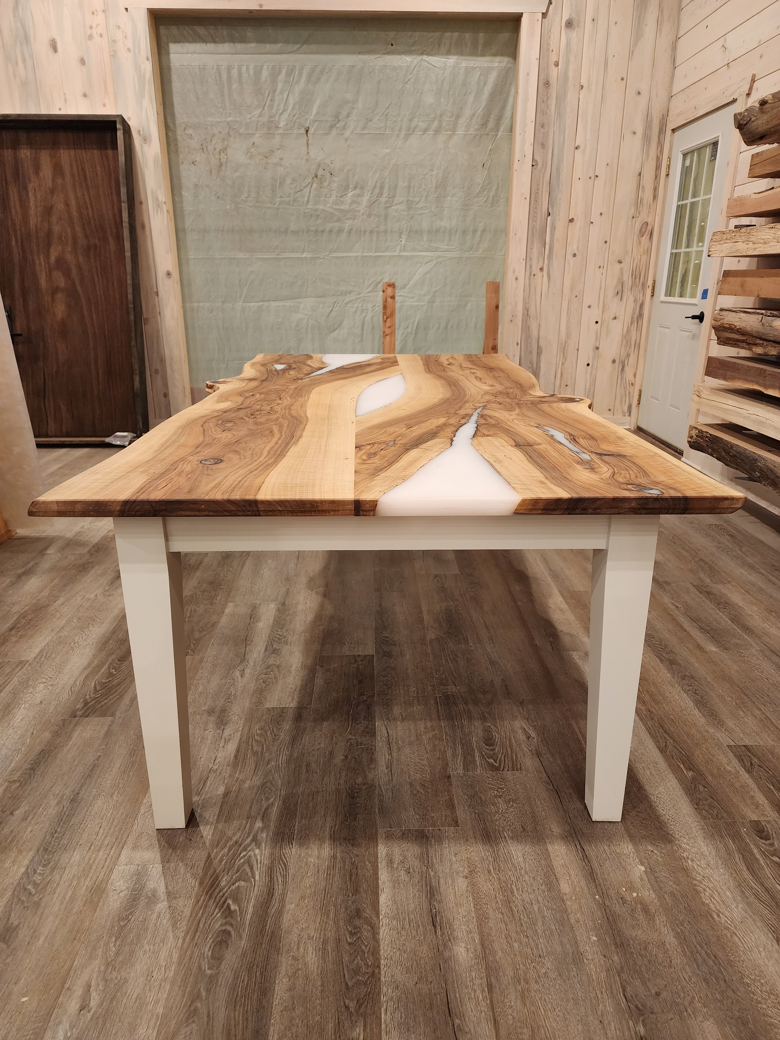 front view of english walnut wood dining table with bookmatched slabs and white epoxy