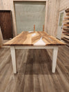 front view of english walnut wood dining table with bookmatched slabs and white epoxy