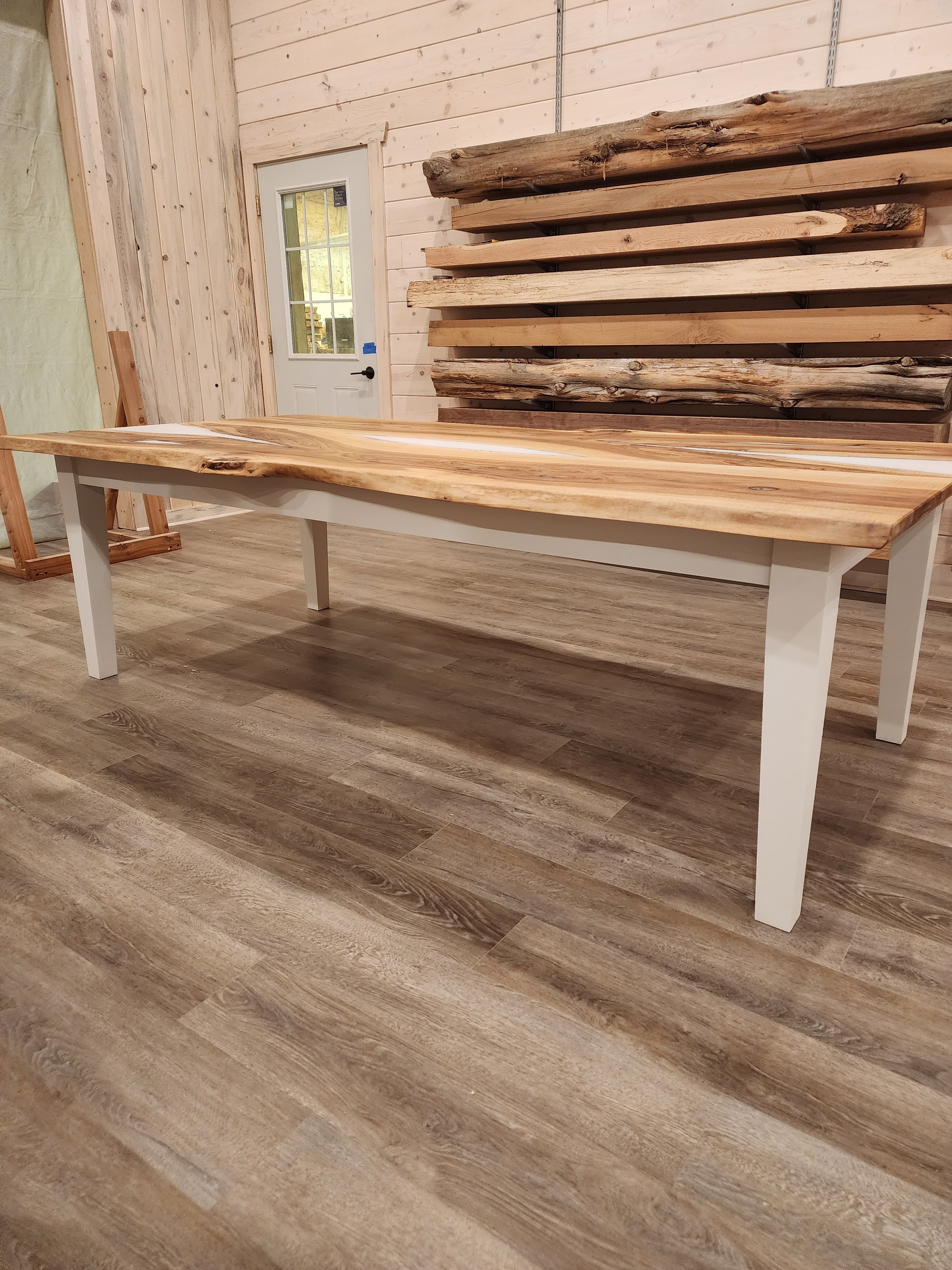 front view of english walnut wood dining table with bookmatched slabs and white epoxy