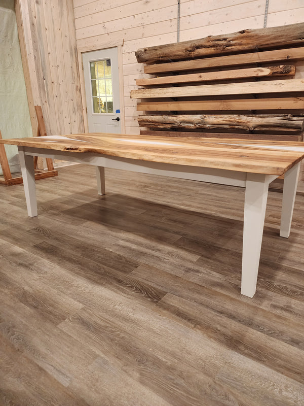 front view of english walnut wood dining table with bookmatched slabs and white epoxy