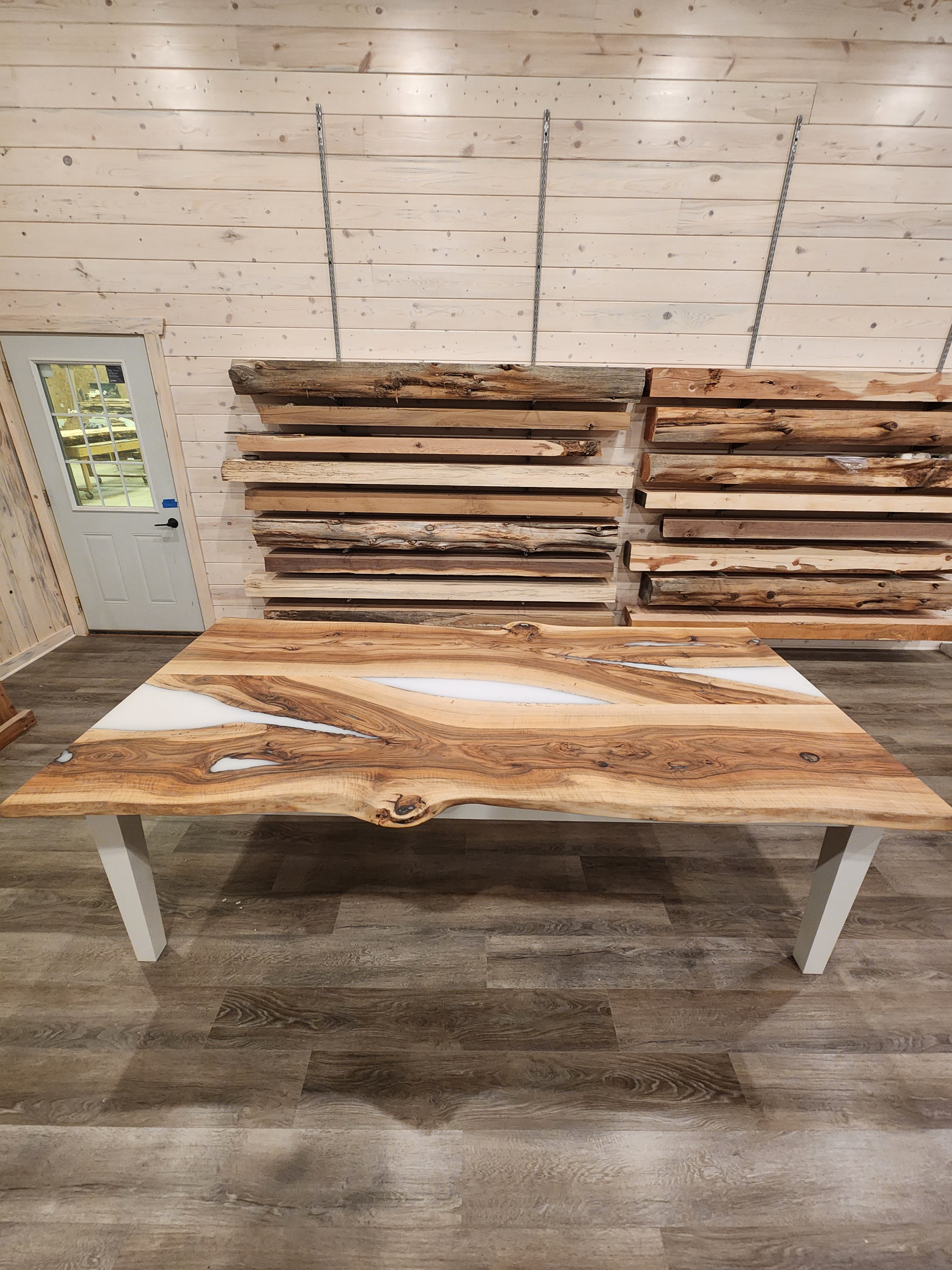 front view of english walnut wood dining table with bookmatched slabs and white epoxy
