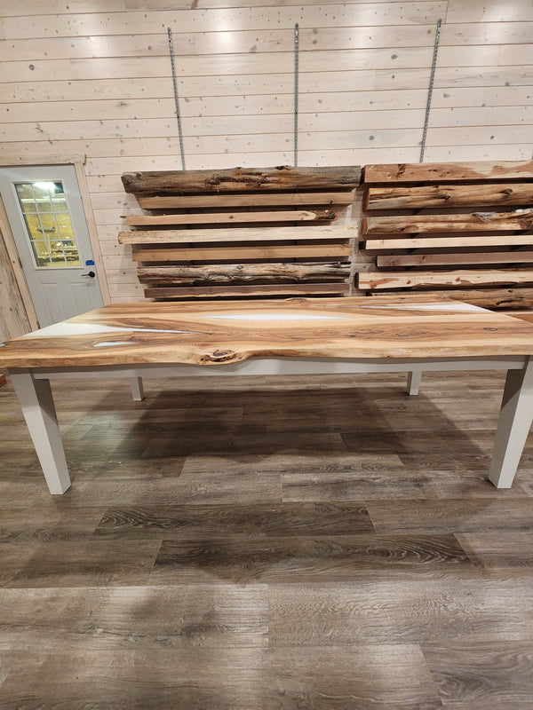 front view of english walnut wood dining table with bookmatched slabs and white epoxy