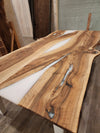 front view of english walnut wood dining table with bookmatched slabs and white epoxy