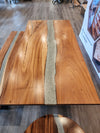 front view of a monkey pod epoxy river table set.
