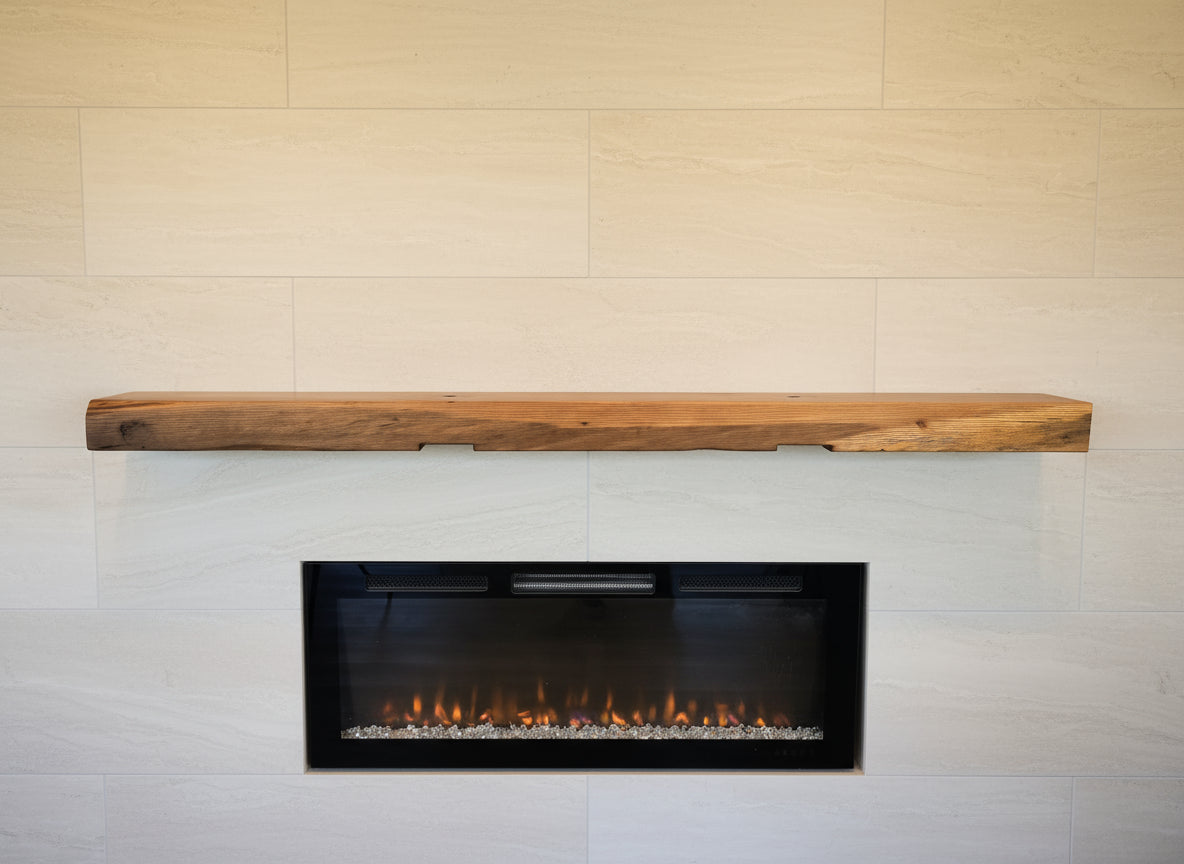 Wooden mantel above a fireplace with wooden wall paneling