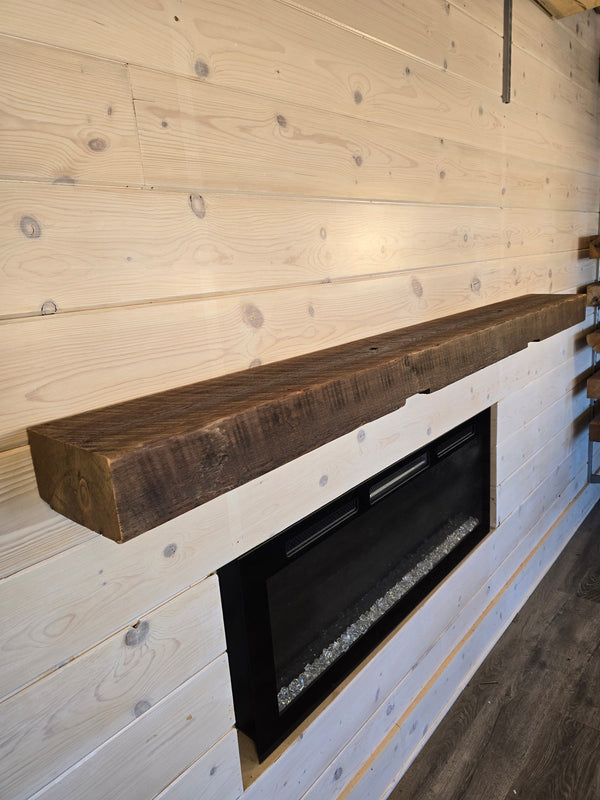 Wooden beam with embedded black fire pit on a wooden floor