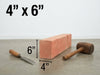 A 4 inch by 6 inch raw wood block with dimensions labeled, shown on a concrete floor against a white wall with a chisel and mallet nearby.