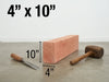 A 4 inch by 10 inch piece of light-colored wood shown with a chisel, mallet, and dimension labels on a concrete floor against a white wall.